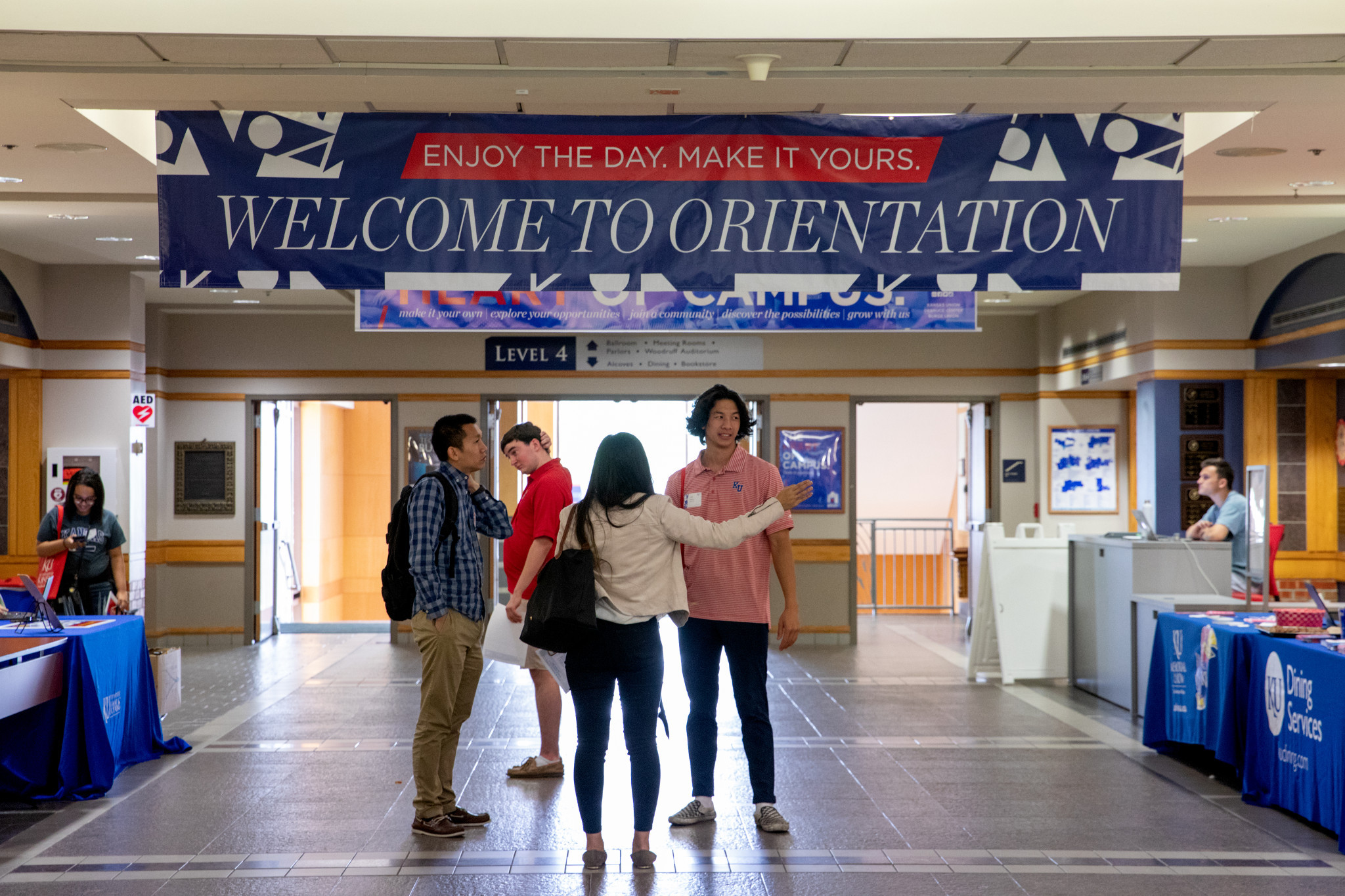 Students socialize below orientation banner at KU Student Union